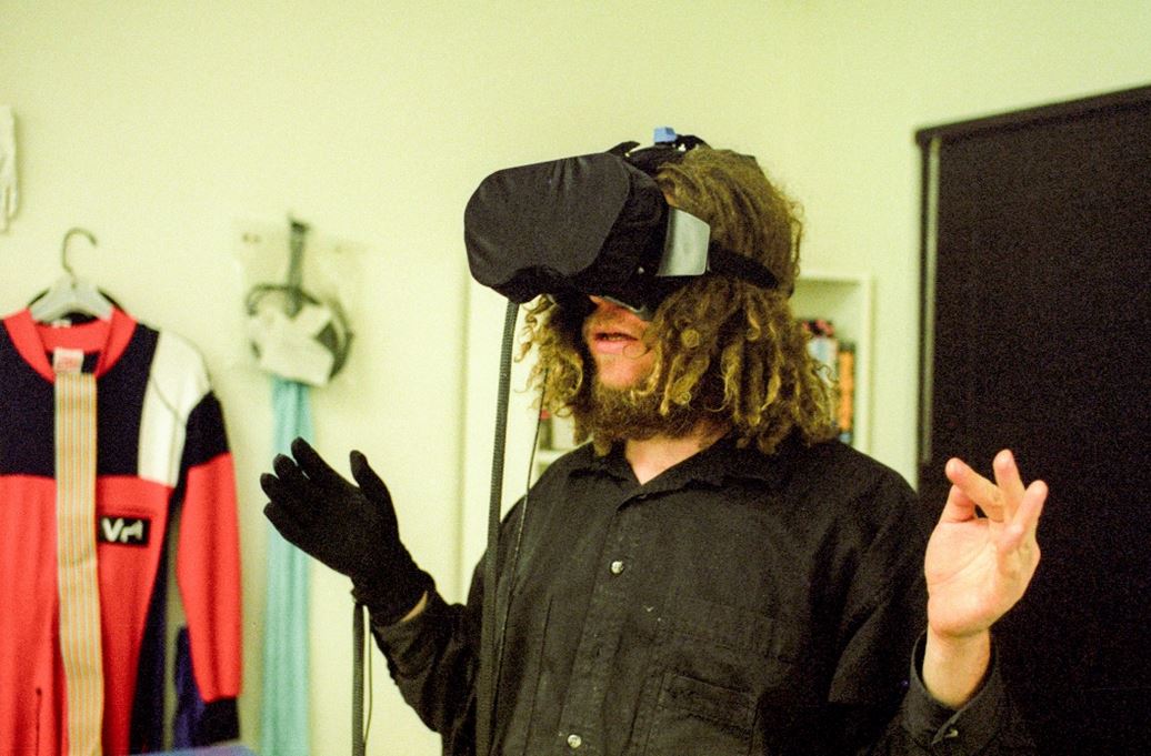 VPL co-founder Jaron Lanier in a DataGlove and head-mounted display (photo by Kevin Kelly) - image source