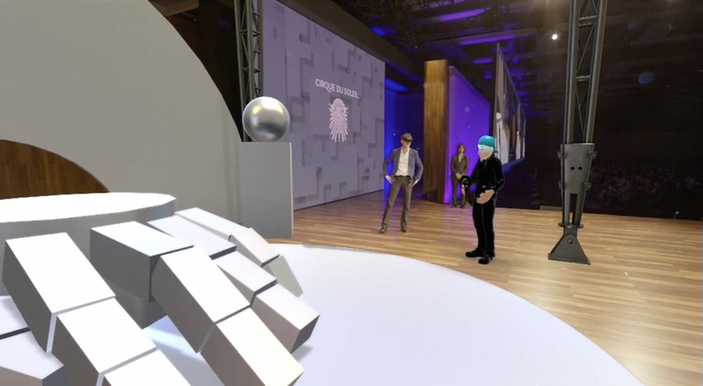 The VR avatar materialized on stage,